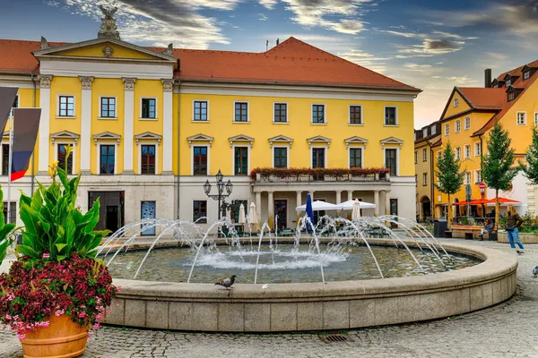 Brunnen auf einem Stadtplatz vor historischen Gebäuden